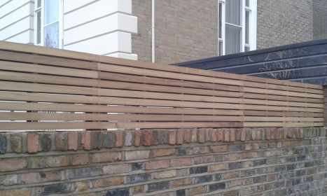 Natural Iroko Slatted Panels Fitted On Top Of Wall