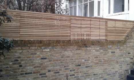 Natural Iroko Slatted Panels Fitted To Sit Flush With Wall