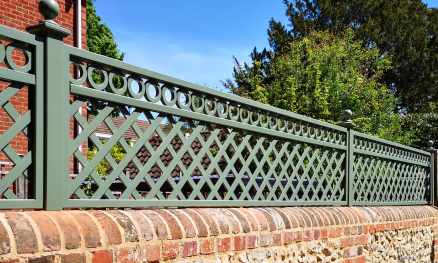 Bespoke diagonal trellis panels with decorative detailing painted in Greenwich Green
