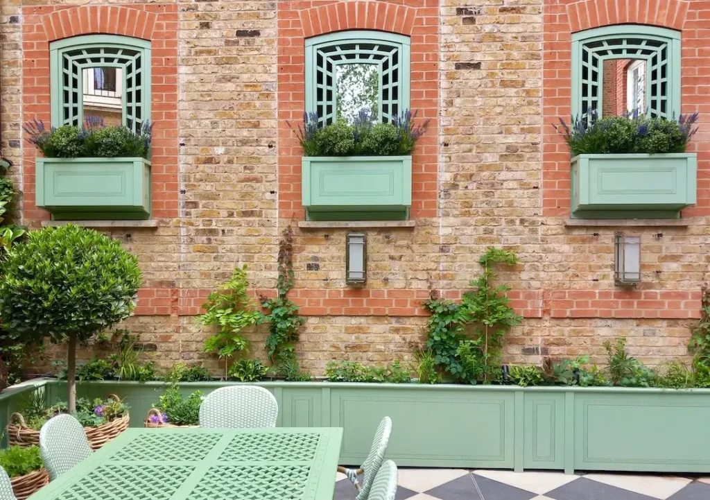 Decorative trellis, trompe l'oeil, and planters painted in Farrow & Ball Breakfast Room Green