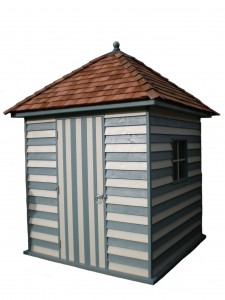 Small wooden shed with striped walls, a shingled pyramid roof, and a locked door.