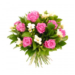 Bouquet of pink roses and white flowers with green leaves.