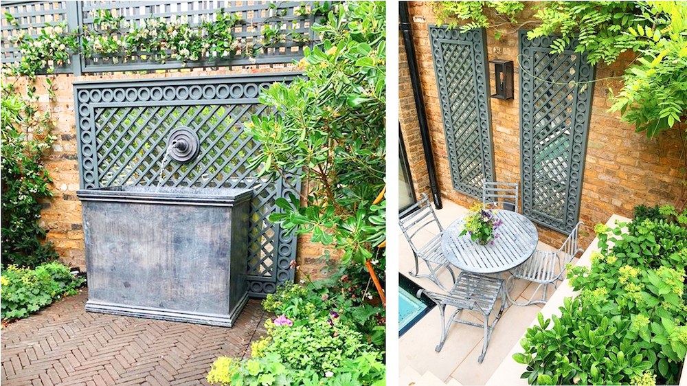 Garden patio with metal trellis, water feature, and outdoor seating surrounded by greenery.