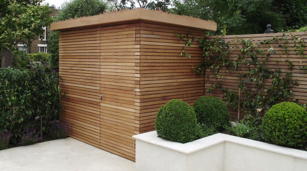 Bespoke slatted garden store with matching slatted panels behind