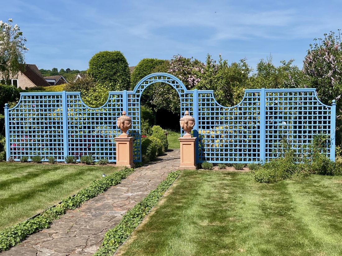 Bespoke decorative trellis with arch details painted in blue