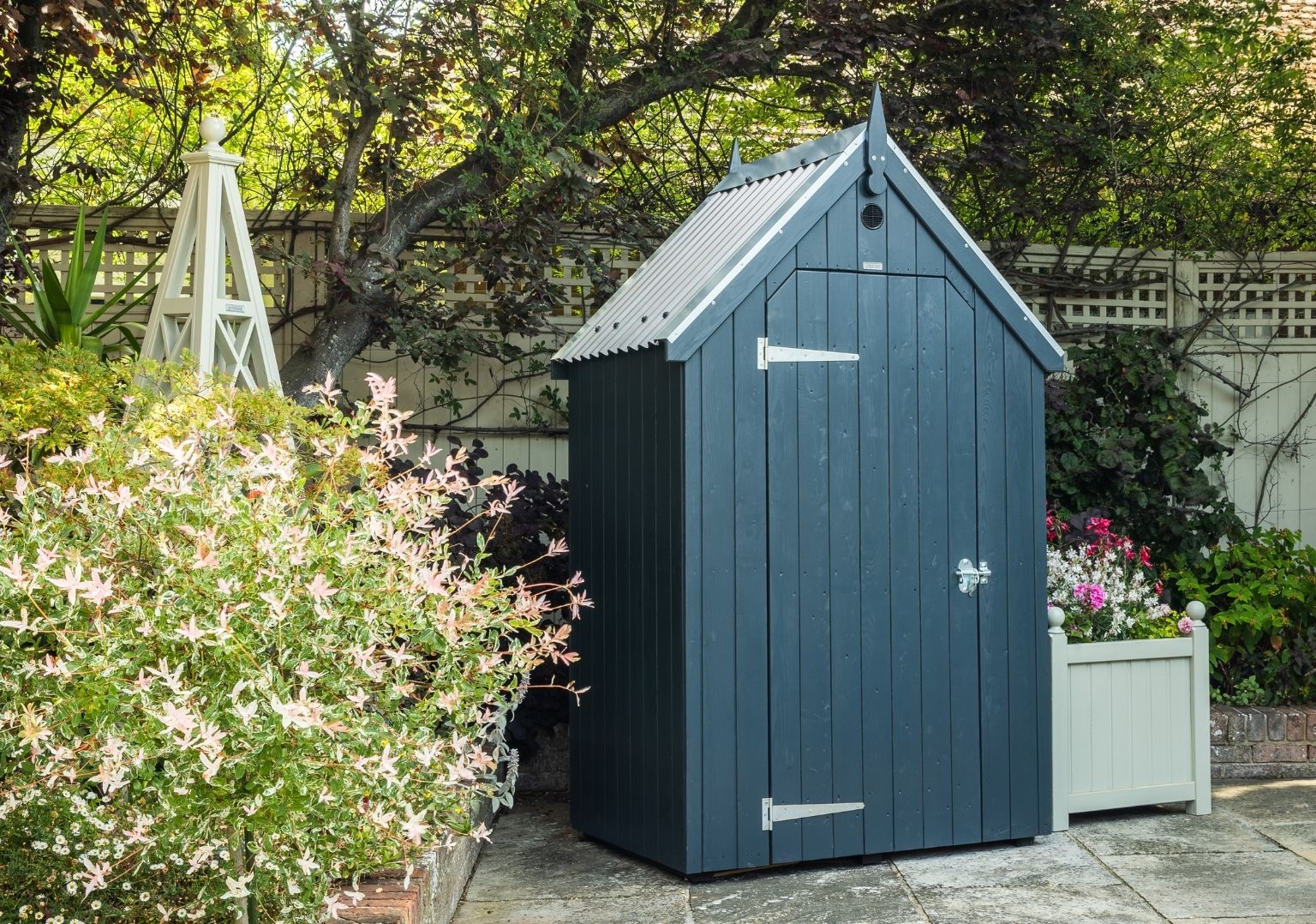 RHS Garden Store in Charcoal and surrounded by Manhattan Grey trellis and fencing.