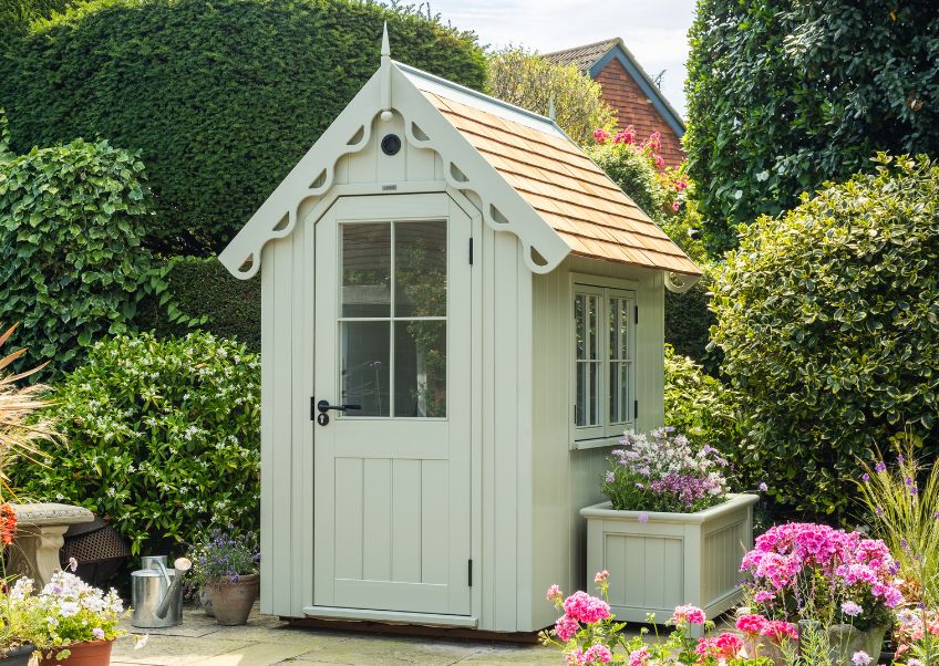 RHS Prestige Victorian Garden Shed in a pretty summer garden