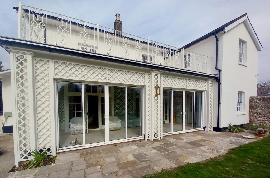 Bespoke trellis painted in Farrow & Ball Wimborne White with matching trellis on the interior walls and ceiling.