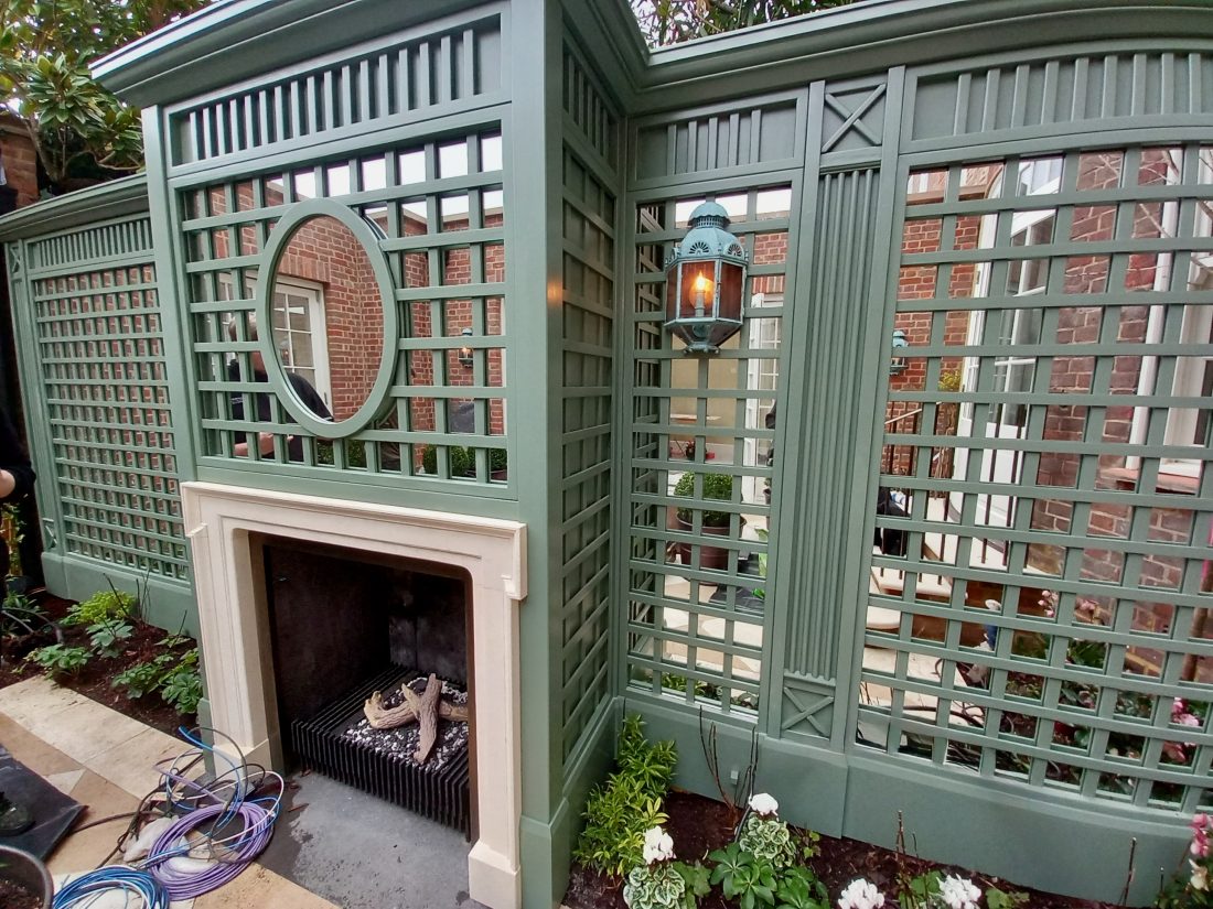 Decorative trellis panels, with mirrored backs and 100mm gaps, painted in Greenwich Green