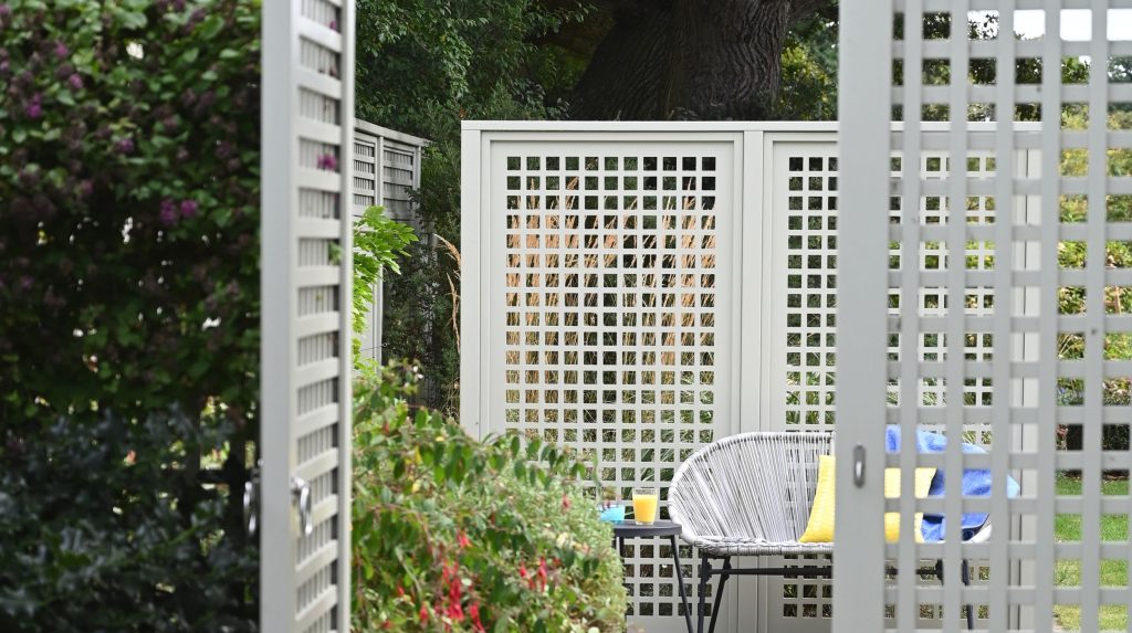 Trellis gate with fencing and WPC trellis behind