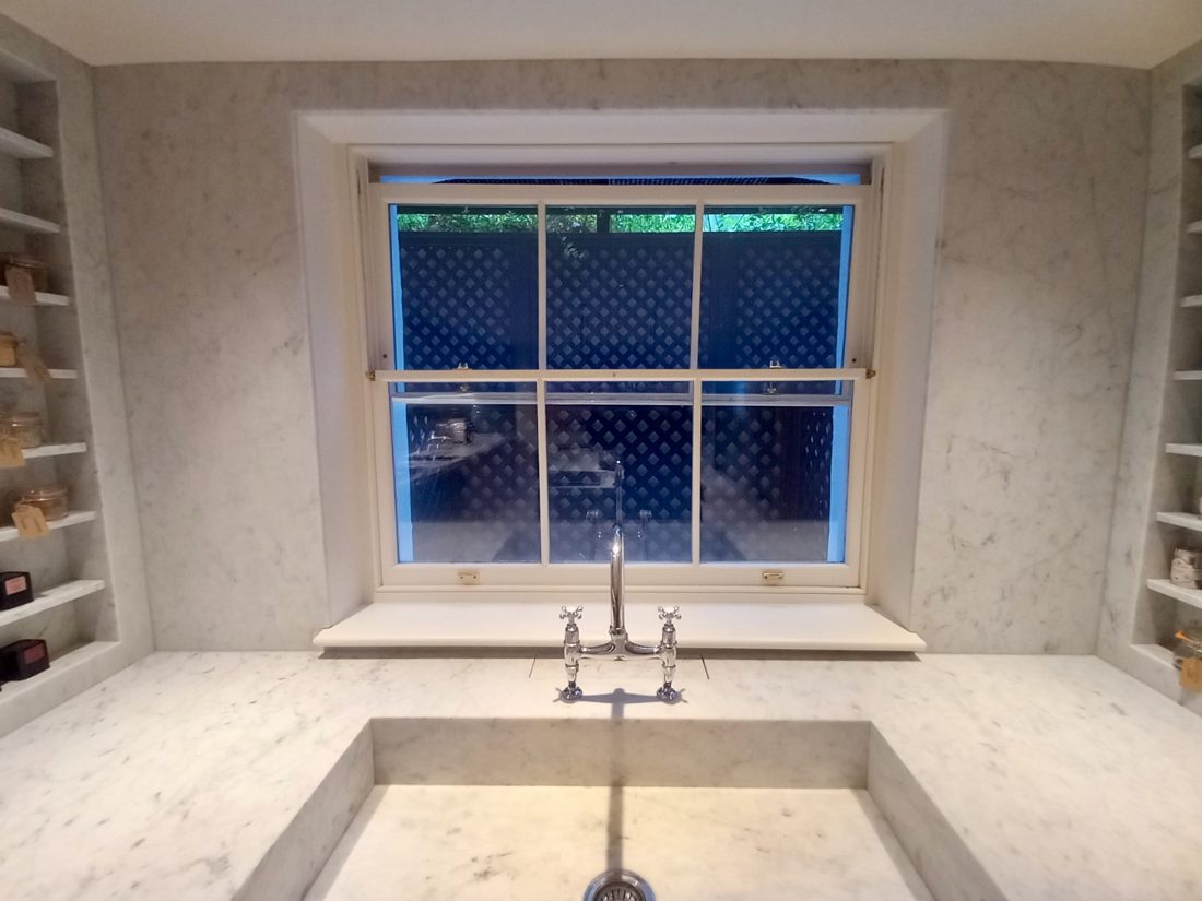 Bespoke diagonal trellis, with a 38mm gap, thermowood painted in bespoke colour Mylands Murmurations making a basement light well more interesting.