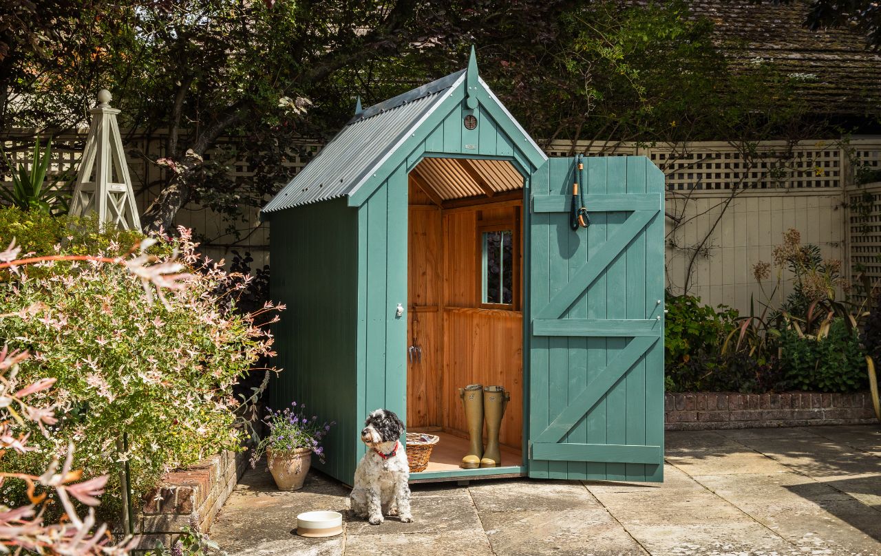 RHS Garden Shed in a traditional garden with obelisk and trellis