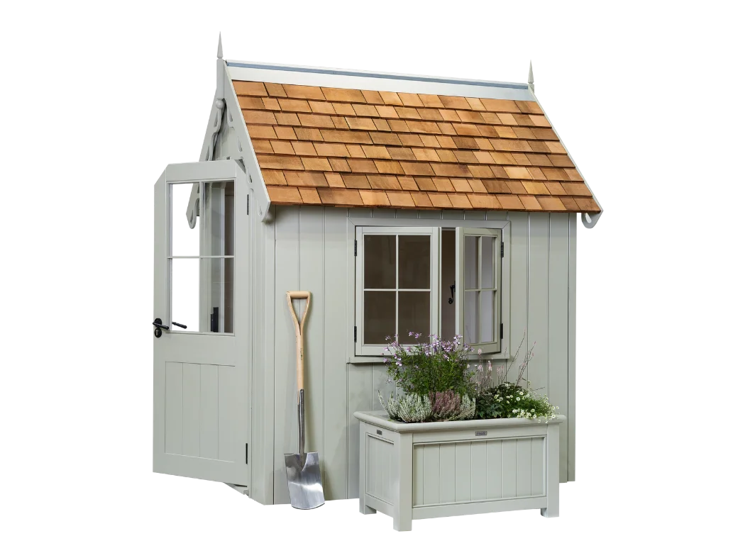 A side view of the RHS Prestige Victorian Garden  Shed with an RHS Prestige Traditional Planter and no background.