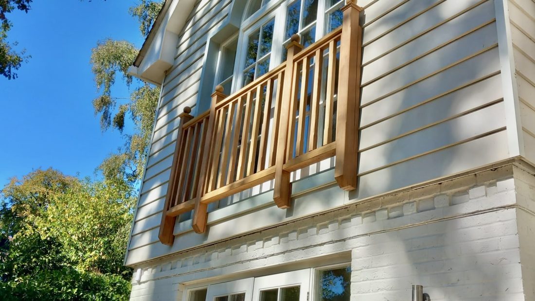 Bespoke Juliet Balcony Balustrade in Iroko on a sunny house