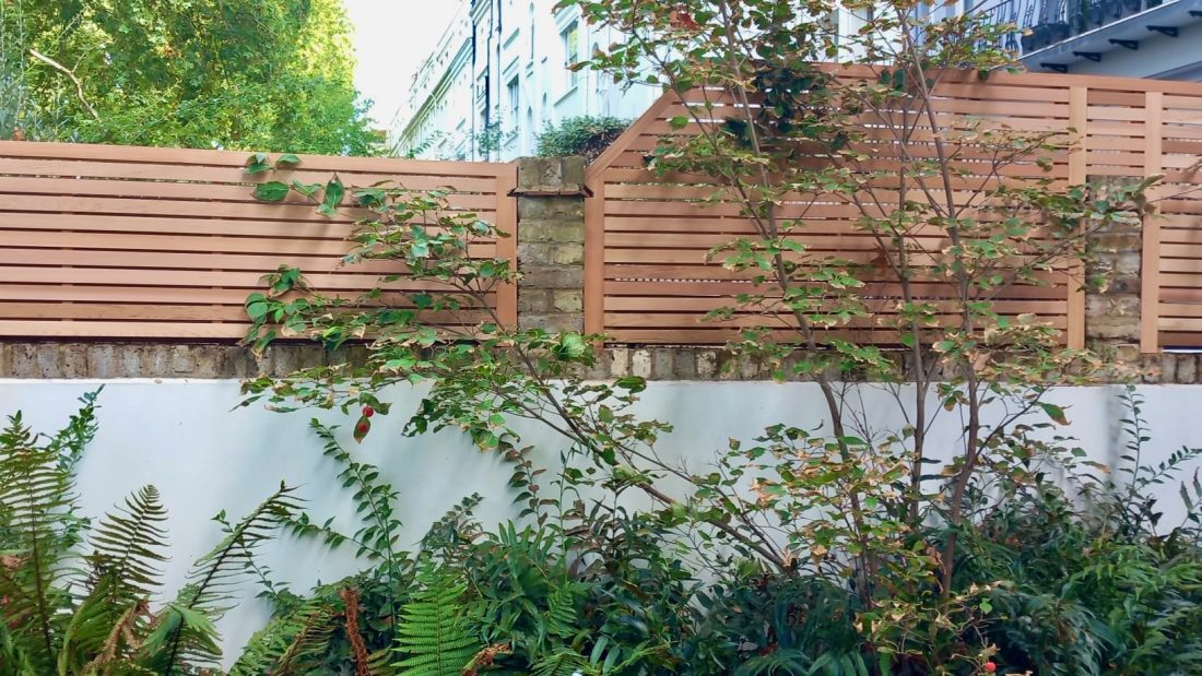 Bespoke angled Slatted Panels in Western Red Cedar atop a wall 45/10