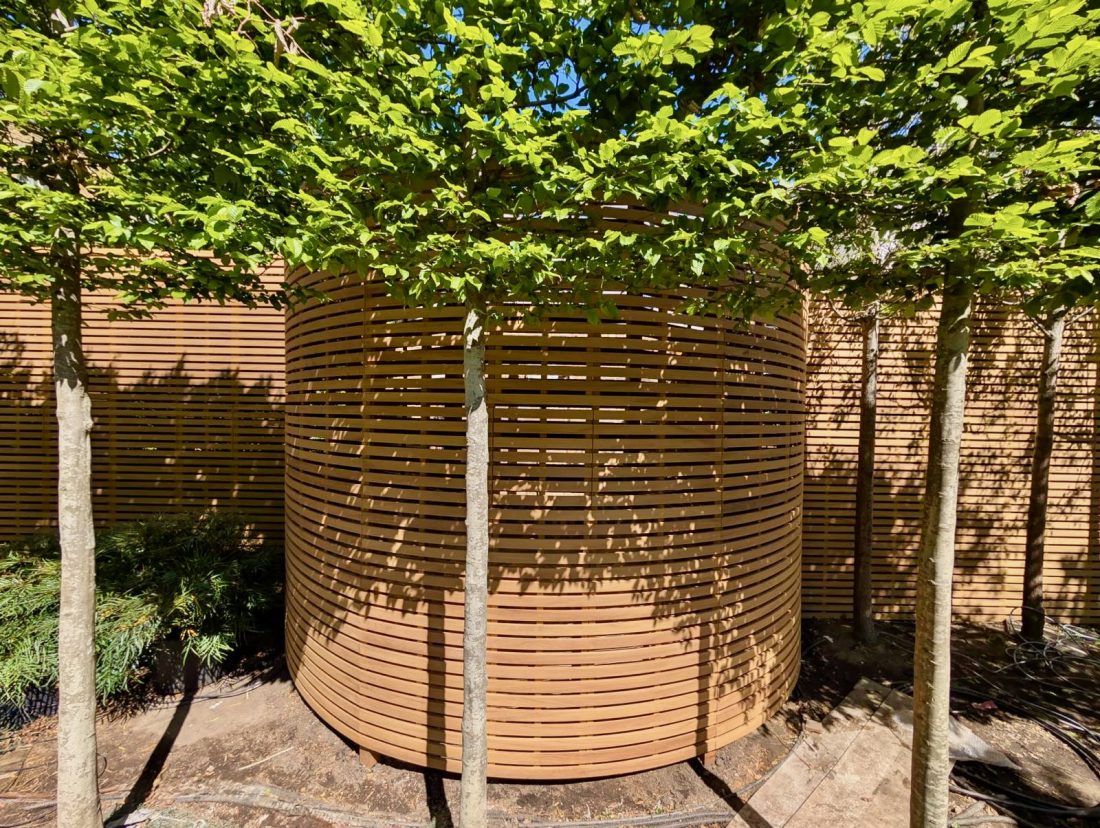 Bespoke slatted panels in Iroko curved to suit wall 45/20